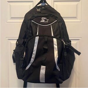 Starter black backpack . Includes multiple compartments and mesh side pockets.